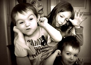 Katie Foley's three children making funny faces.