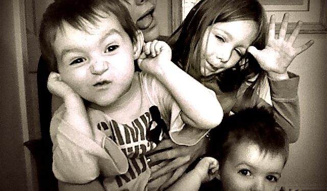 Katie Foley's three children making funny faces.