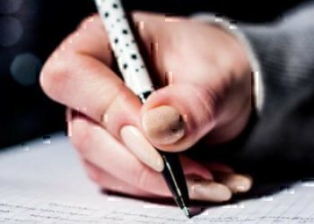 A women writing with a pen.