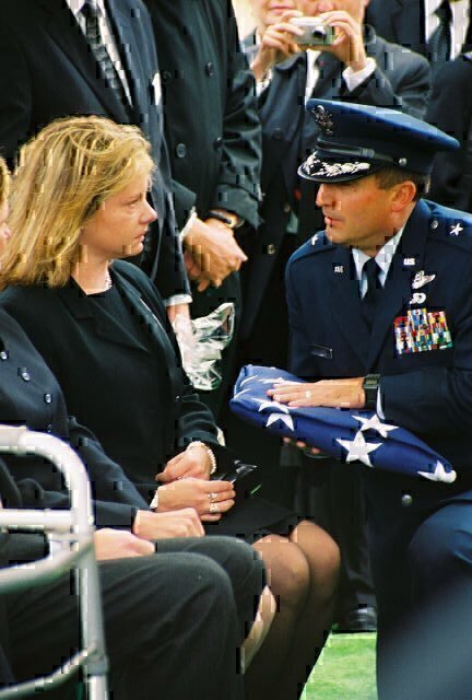Presentation of flag to daughter Laura at Larry's funeral at Arlington, 35 years after he'd been shot down in Laos. 