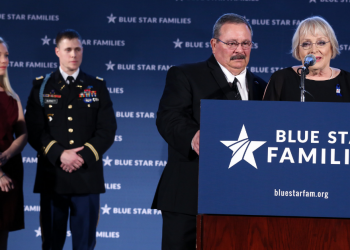 Ashley and Chase Burnett look on as Judy and Ken Osborne receive the 2017 Blue Star Neighbor Award at Blue Star Families’ Celebration.