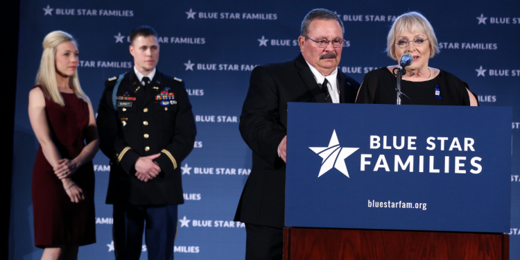 Ashley and Chase Burnett look on as Judy and Ken Osborne receive the 2017 Blue Star Neighbor Award at Blue Star Families’ Celebration.