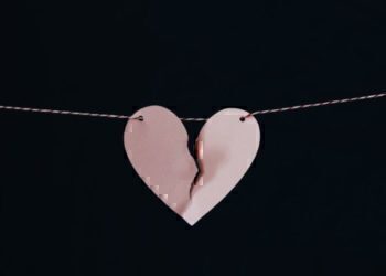 A ripped heart hung up on a string.