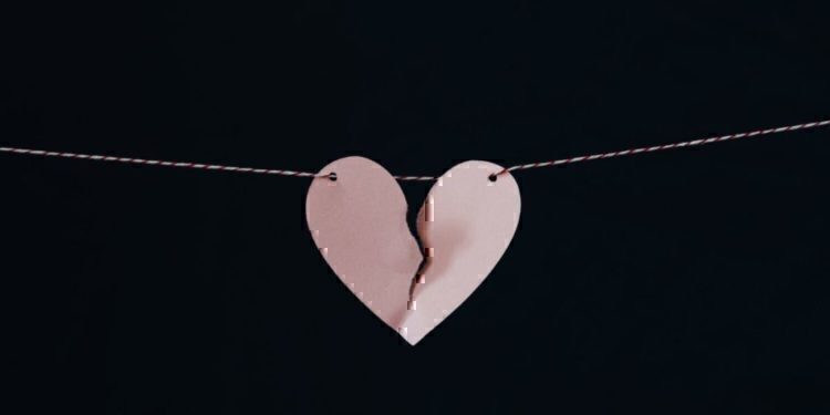 A ripped heart hung up on a string.