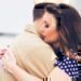 A wife hugging her husband before he leaves for his deployment.