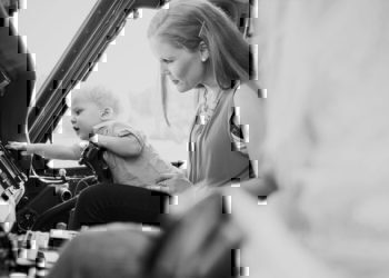 A mother with her child looking through some merchandise.