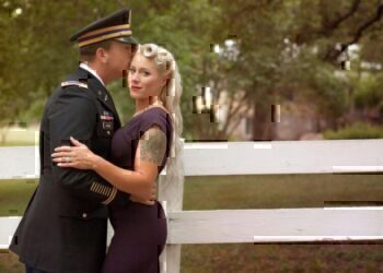 A service men and his wife have an intimate moment before the camera.