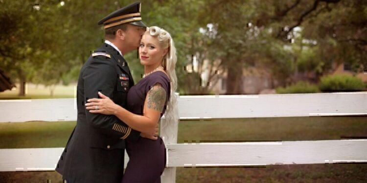 A service men and his wife have an intimate moment before the camera.