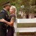 A service men and his wife have an intimate moment before the camera.