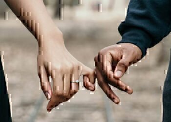 An engaged couple holds hands as they plan their life insurance policy with Navy Mutual