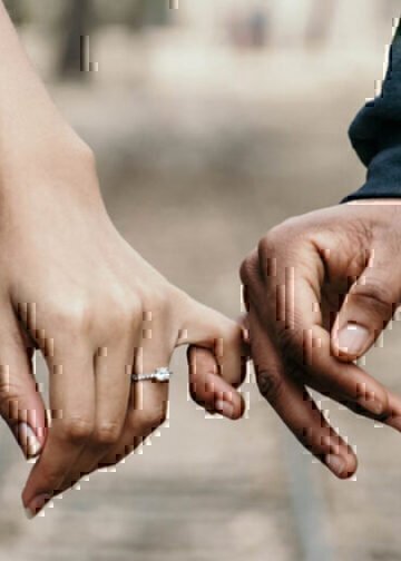 An engaged couple holds hands as they plan their life insurance policy with Navy Mutual