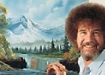 Bob Ross working on one of his famous paintings.