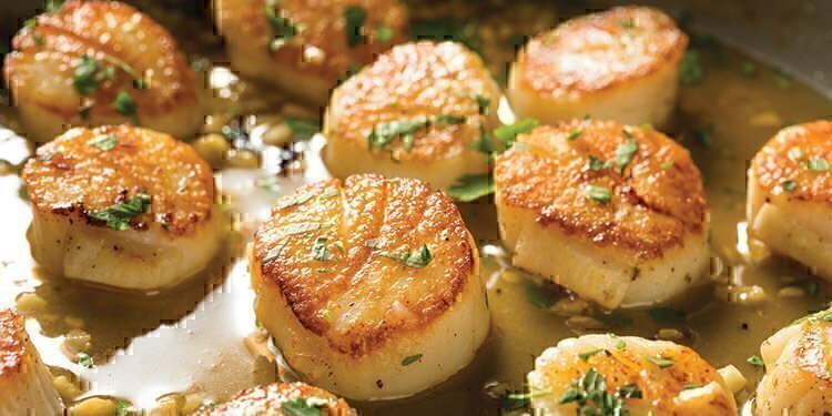 Wonderfully seasoned and cooked scallops that are about to be finished cooking.