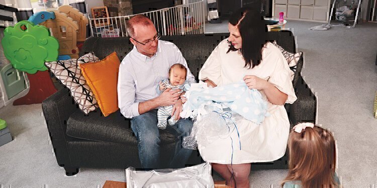 Hannah Kimmick and her family hold their newest member.