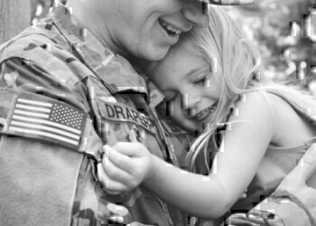 A father holding his daughter after a reunion.