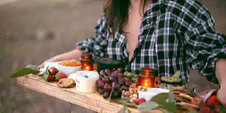 A young women carrying her homemade Thankgiving Day appetizer platter.