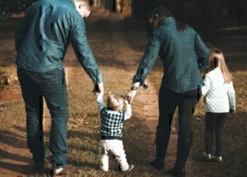 A family walking down a dirt path together.