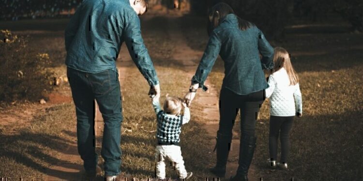 A family walking down a dirt path together.