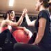 Two women high-fiving each other after completing a hard workout.